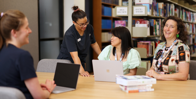 #caption104718 People sitting in Austin Library bookroom